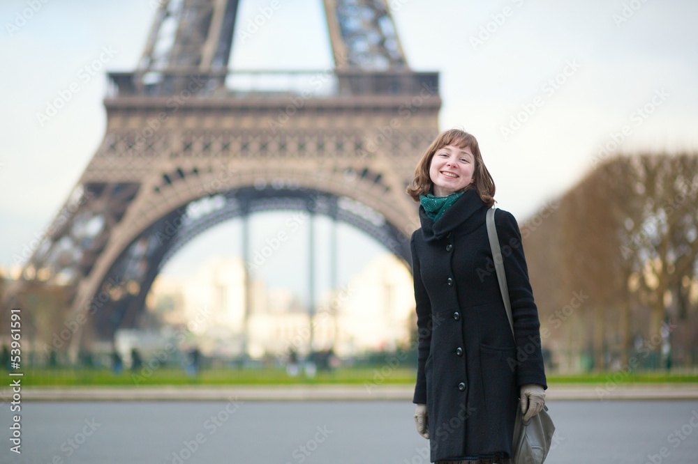 Beautiful girl near the Eiffel tower