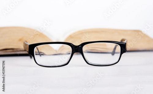 glasses in front of books