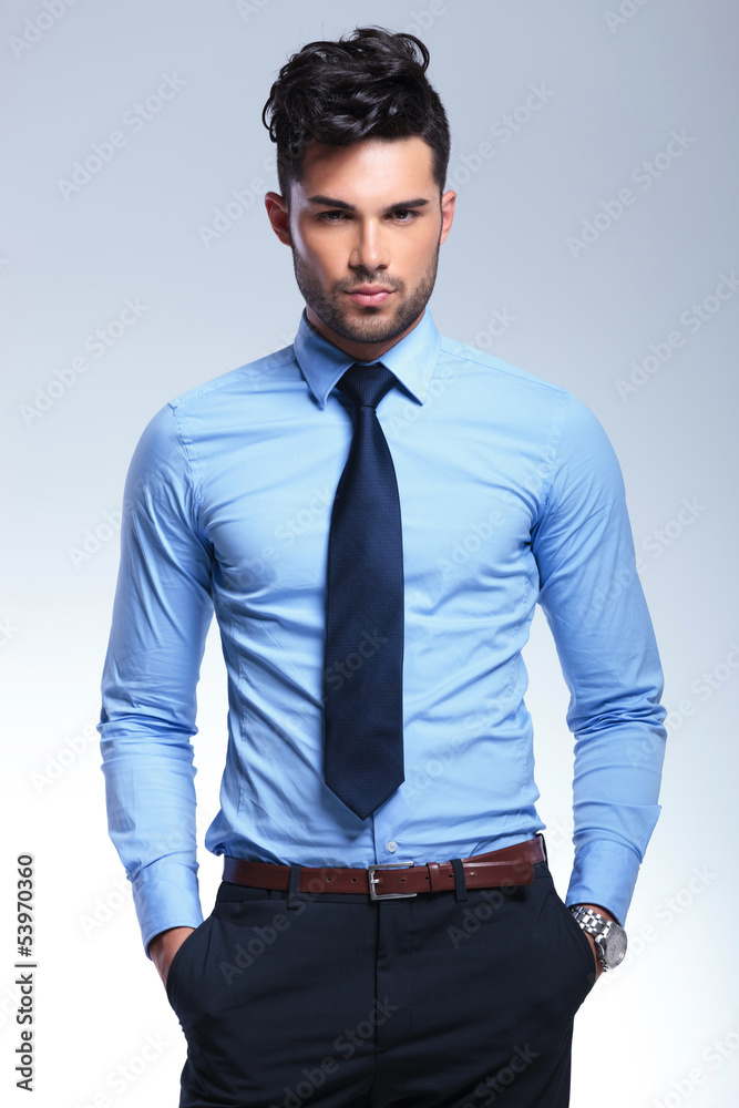 Fototapeta premium business man looks at you with hands in pockets