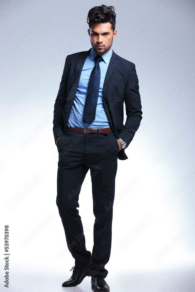 business man with hands in pockets looks at you business man with hands in pockets looks at you