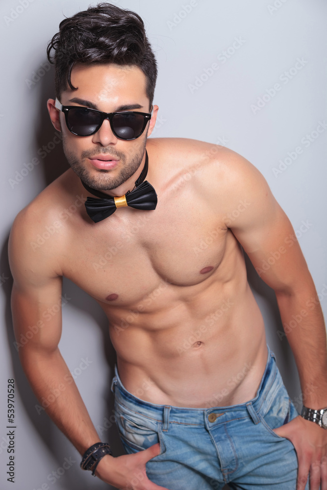 topless young man with hands in pockets topless young man with hands in pockets