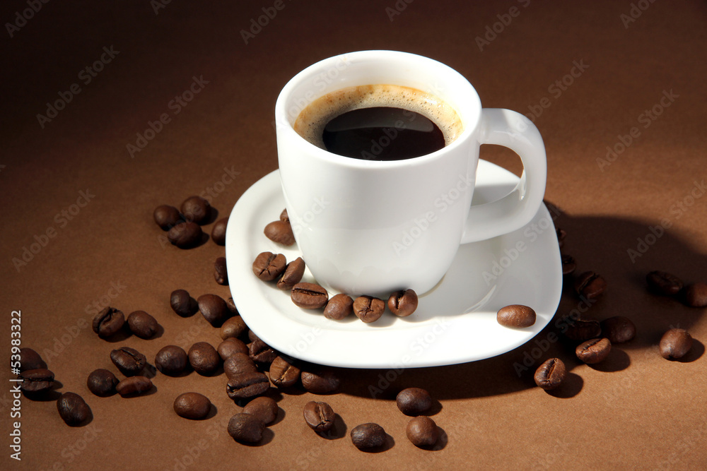 Cup of coffee with coffee beans on brown background Cup of coffee with coffee beans on brown background