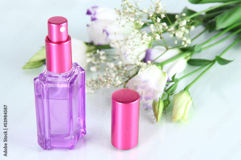 Perfume in bottle and flowers isolated on white Perfume in bottle and flowers isolated on white
