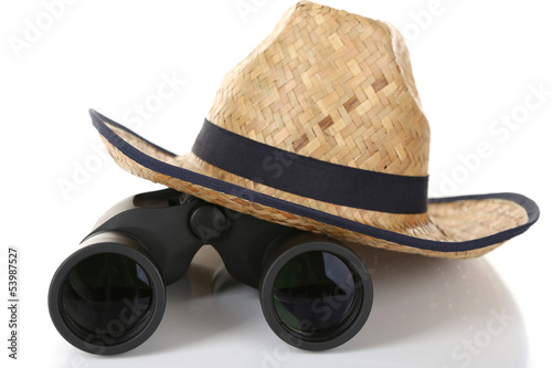 Black modern binoculars with straw hat isolated on white