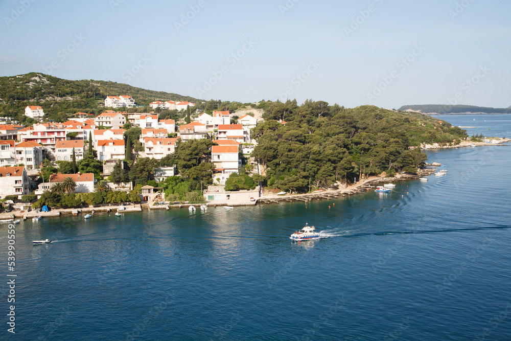 Pilot Boat Past Homes in Croatia