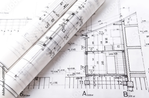 Architect rolls and plans project blueprint