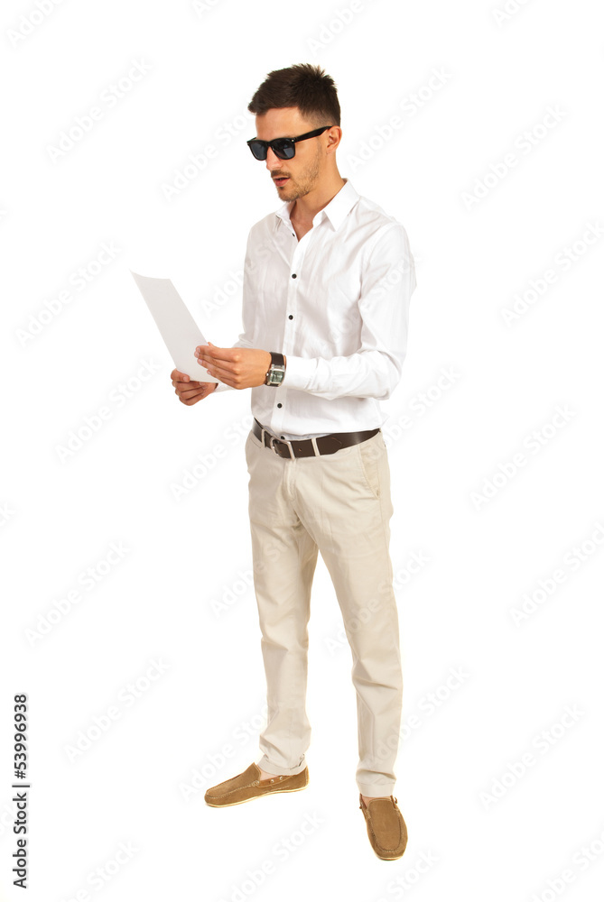 Man with sunglasses reading paper Man with sunglasses reading paper