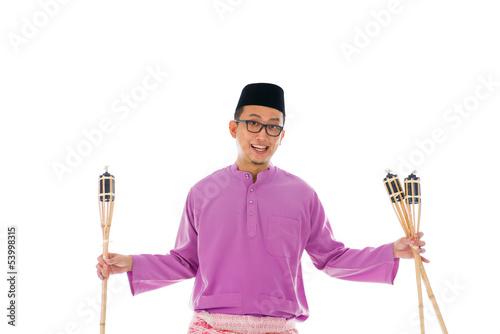 Malay man celebrating hari raya the month after ramadan photo