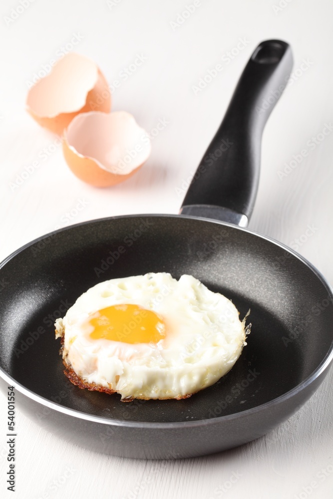 Fried egg on frying pan an egg shells. Fried egg on frying pan an egg shells.