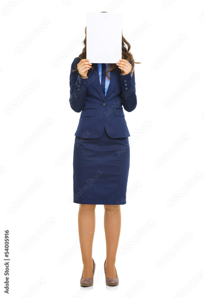 Full length portrait of business woman hiding behind blank paper Full length portrait of business woman hiding behind blank paper