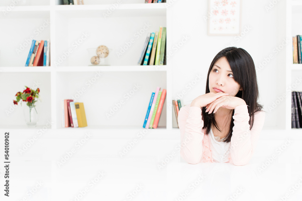 attractive asian woman thinking in the room
