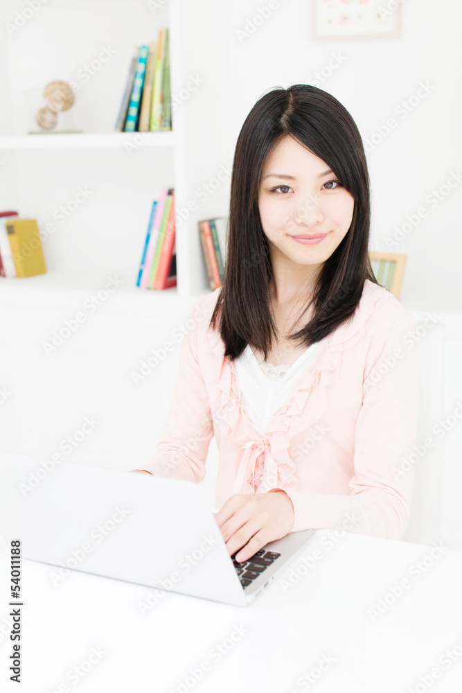 attractive asian woman using laptop in the room attractive asian woman using laptop in the room