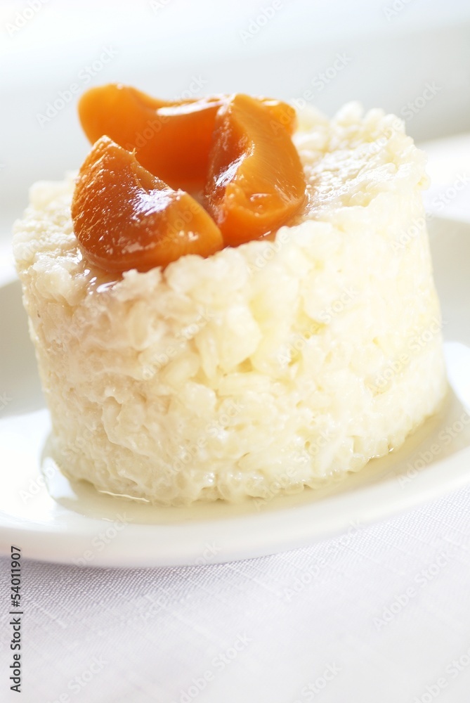Sweet rice pudding with apricots on white plate. Sweet rice pudding with apricots on white plate.
