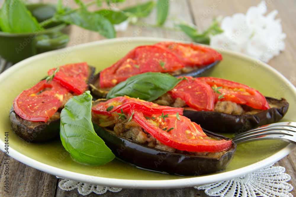 Grilled eggplant with tomatoes and meat.