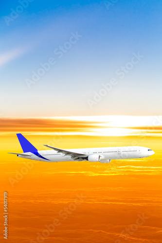 Airplane in the sky at sunset. A passenger plane in the sky