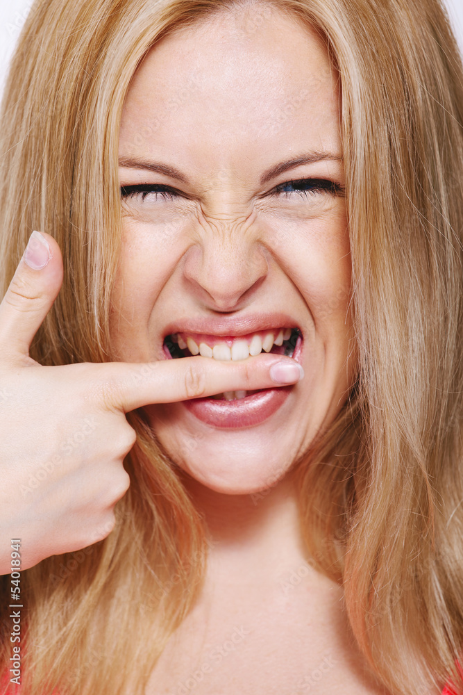 Happy blonde woman biting his finger. Isolated on white. Happy blonde woman biting his finger. Isolated on white.
