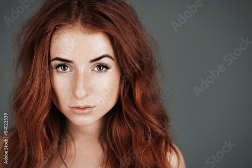 red-haired girl with freckles in the studio. Teen girl with brig
