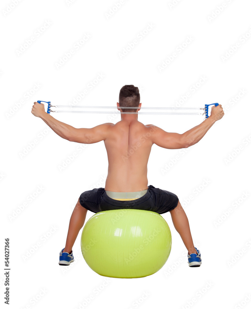 Strong man practicing exercises with dumbbells sit on a ball Strong man practicing exercises with dumbbells sit on a ball