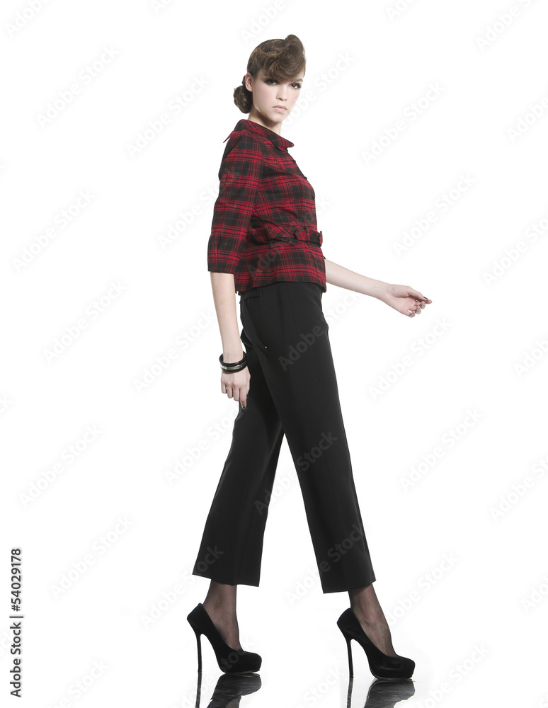 Attractive young fashion model posing in light background Attractive young fashion model posing in light background