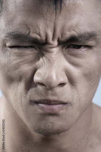 Close up of young mans face, irritated