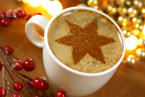 Cup of coffee and cinnamone star. photo