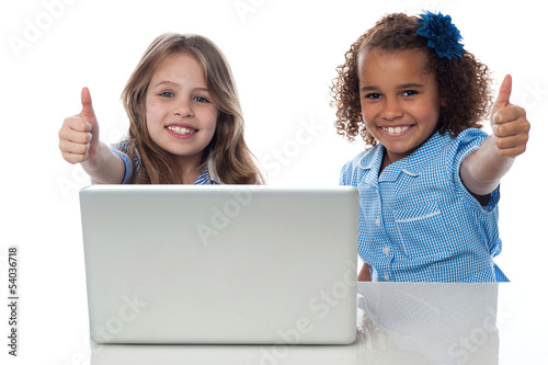 Two happy kids showing thumbs up photo