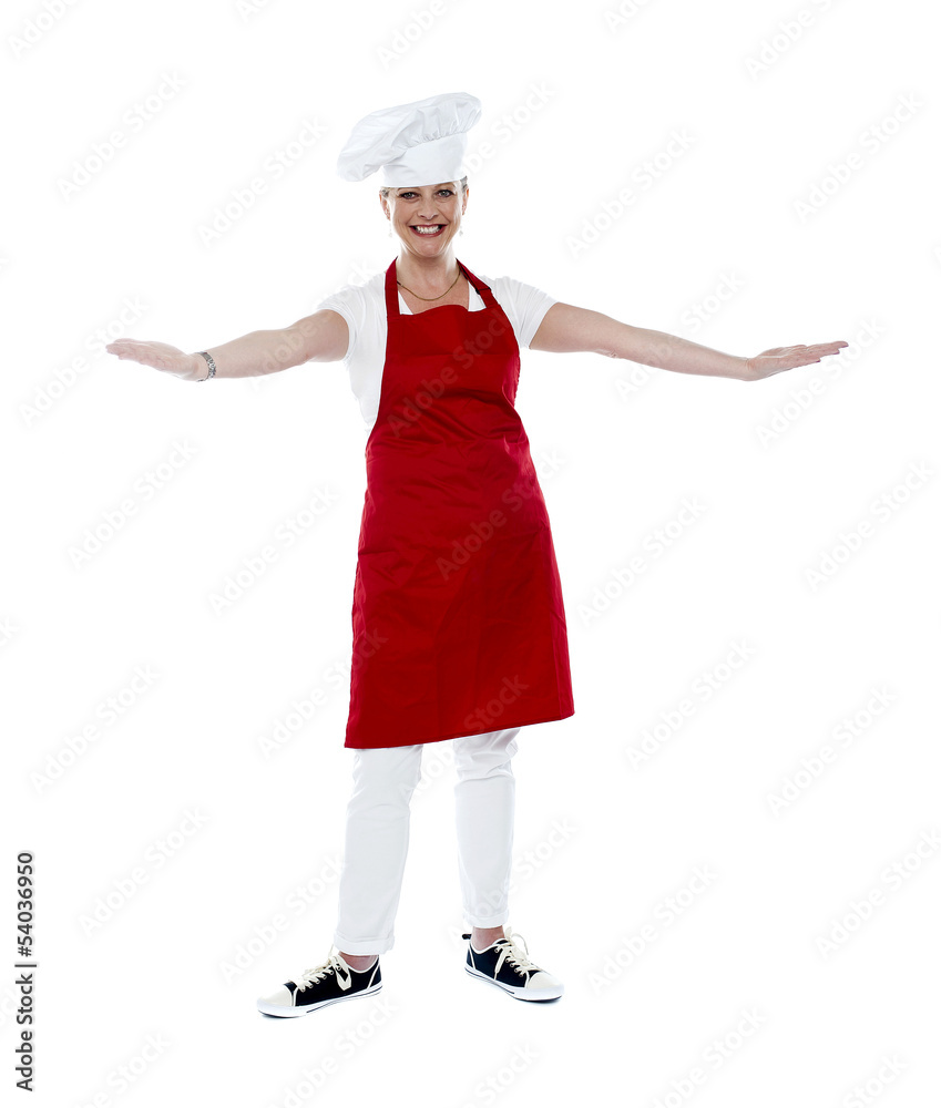 Attractive female chef in red apron and toque Attractive female chef in red apron and toque