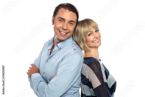 Cheerful couple leaning on each other