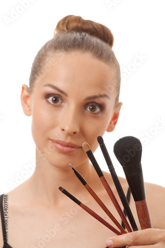 woman showing her makeup brushes, isolated on white background