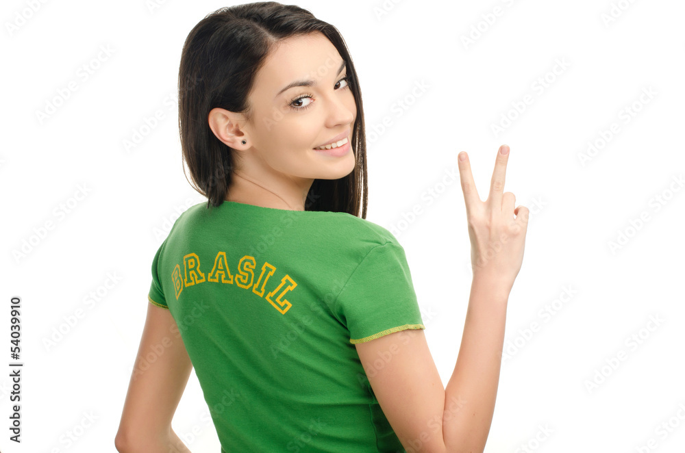 Girl with Brasil written on her green t-shirt signing victory. Girl with Brasil written on her green t-shirt signing victory.