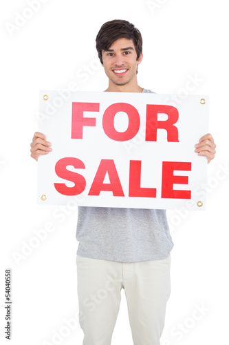 Man holding a for sale panel