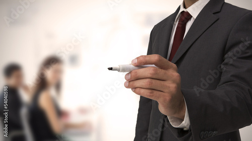 Businessman holding a marker