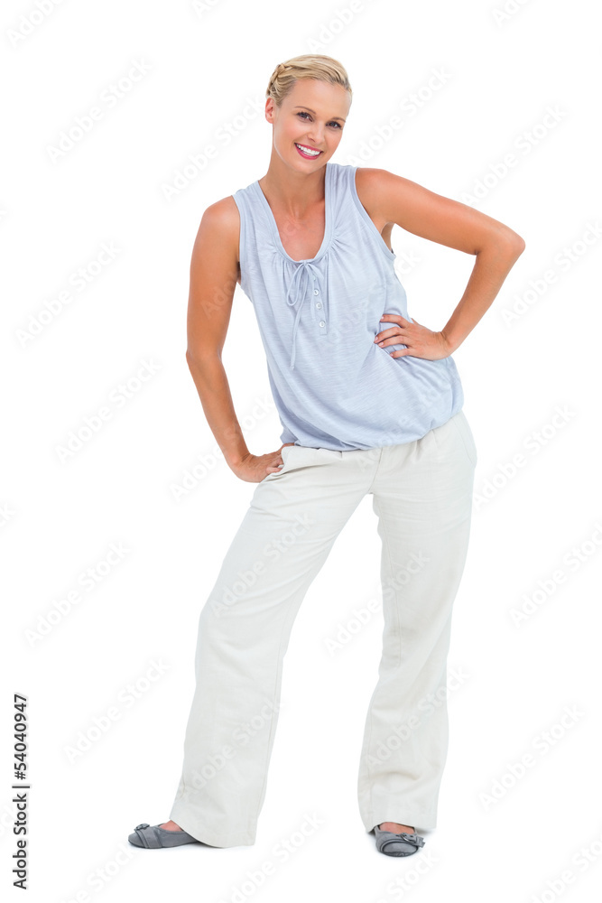 Blonde woman smiling at camera and bending with hands on hips Blonde woman smiling at camera and bending with hands on hips