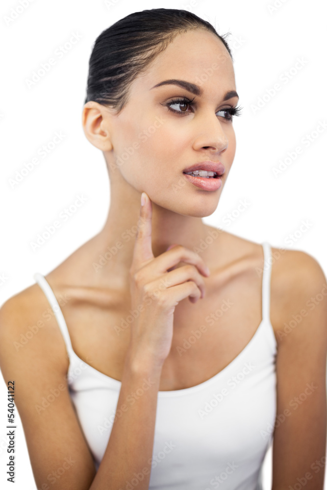 Beautiful woman with finger on her face looking away Beautiful woman with finger on her face looking away