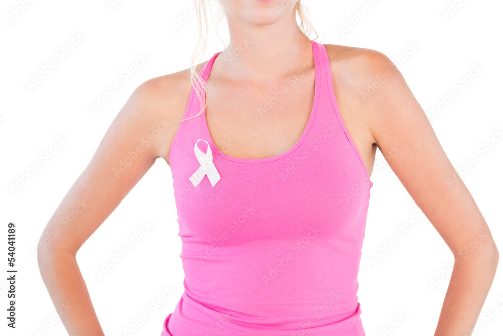 Woman wearing pink tank top and breast cancer ribbon