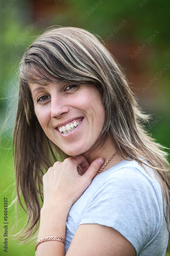 Smiling Caucasian woman portrait with long hair, outdoors