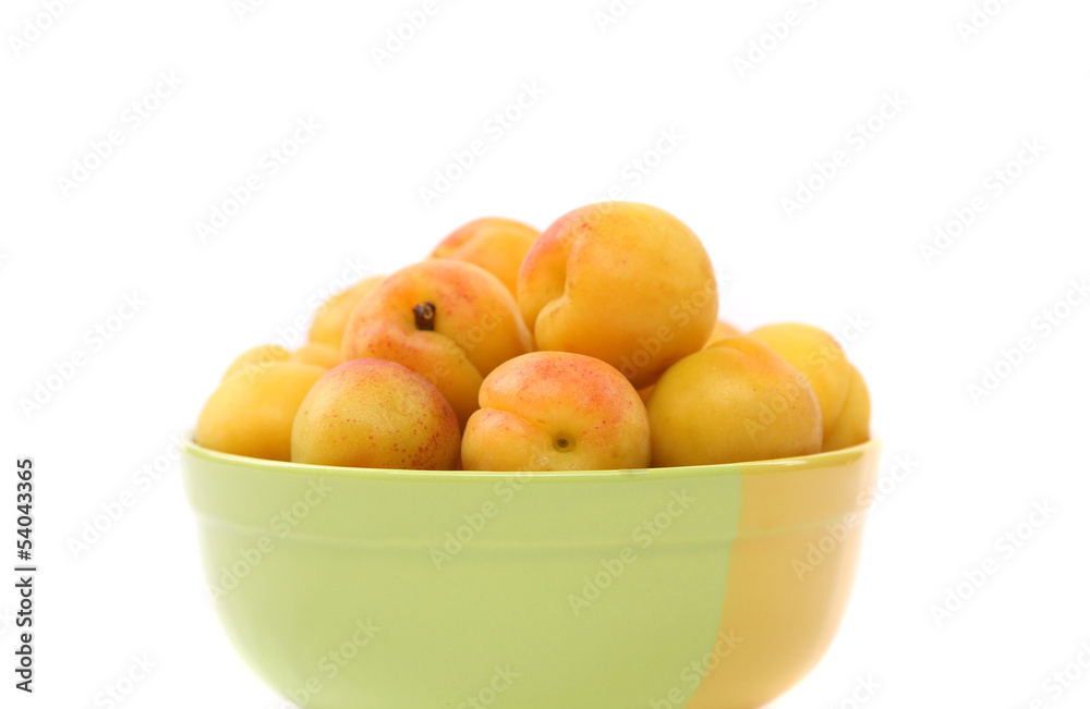 fresh apricots in the bowl on a white background