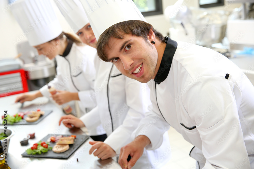 Smiling young man in restaurant kitchen
