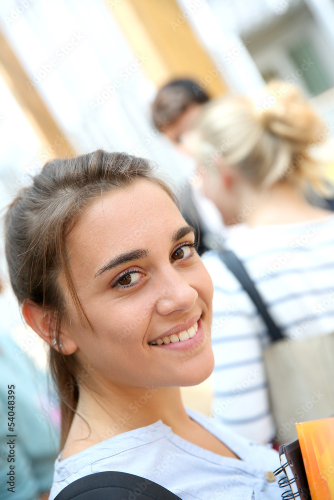 Portrait of teenage girl holding notebooks at school Portrait of teenage girl holding notebooks at school
