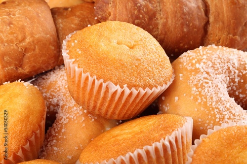 Lemon cupcakes, donuts, and croissants close-up.