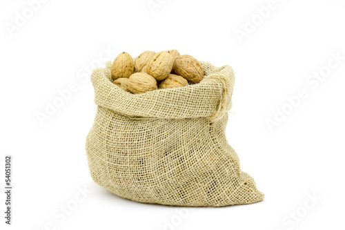 Burlap sack full of whole walnuts