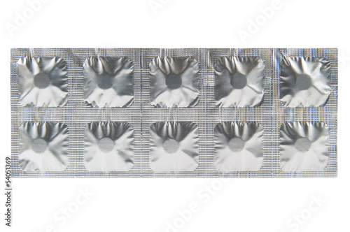Closed up medicine tablet in aluminum foil strip background