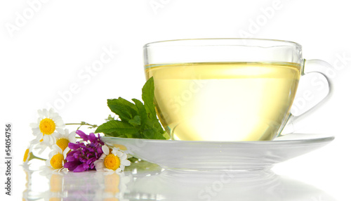 Cup of herbal tea with wild flowers and mint, isolated on white