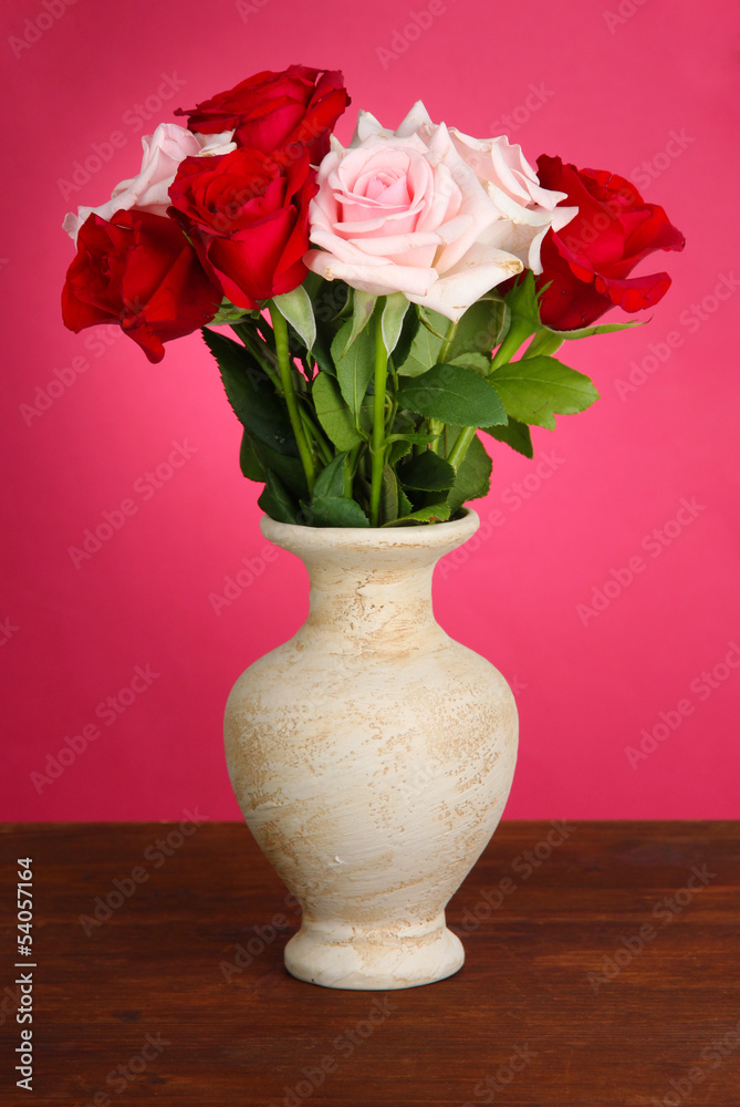Beautiful bouquet of roses in vase with gift