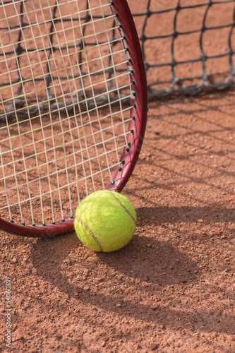 tennis racket and balls on the clay court © Ryzhkov Oleksandr
