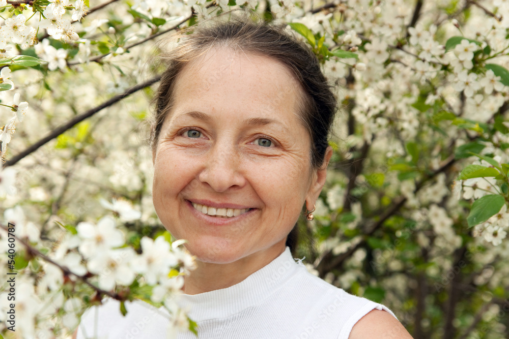 Portrait of beautiful mature woman in spring garden. Portrait of beautiful mature woman in spring garden.