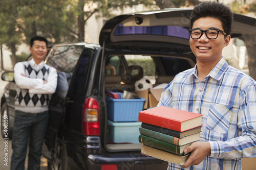 Boy unpacking car for college © xixinxing