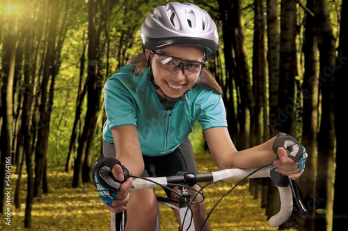 woman riding a bike outside in forest