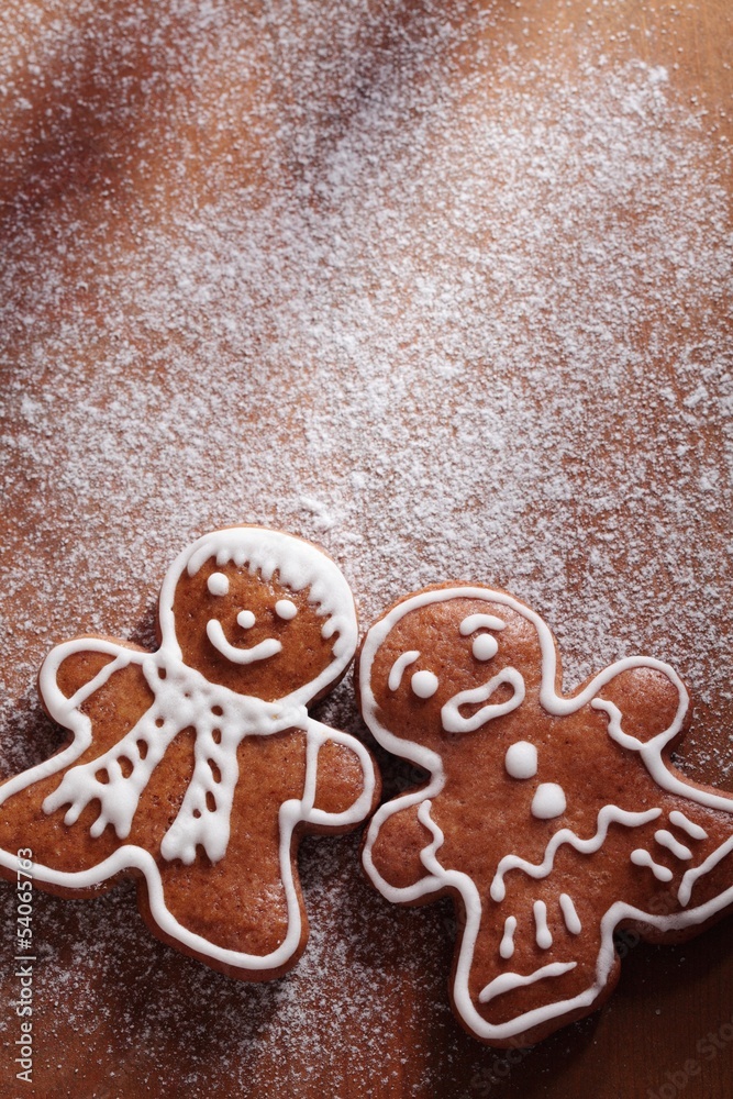 Christmas gingerbread men on sugar background with copy space