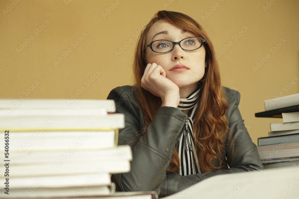 A young woman dreaming while studying A young woman dreaming while studying